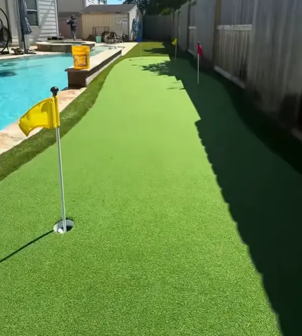 Artificial turf putting green by pool in houston