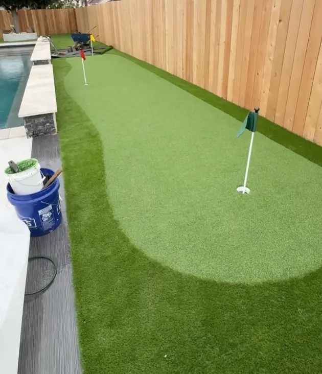 Backyard putting green by pool installation houston turf